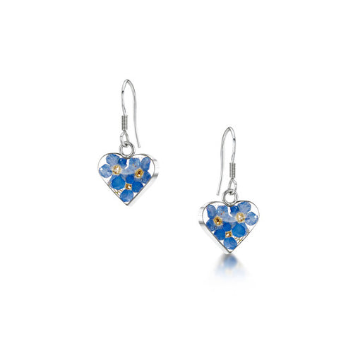 The image shows a pair of sterling silver earrings with drop loop fastenings. The earrings are heart-shaped and contain real forget-me-not flowers contained within resin mounted in sterling silver.
