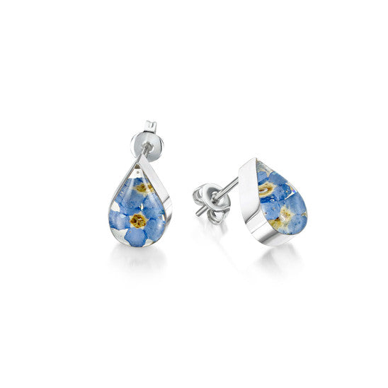 The image shows a pair of sterling silver earrings with stud fastenings, the earrings are teardrop-shaped and contain real forget-me-not flowers contained within resin and mounted in sterling silver.