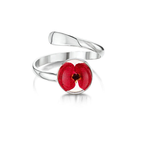 The image shows a sterling silver finger ring with a round bezel containing real poppy flowers in a clear resin mounted in sterling silver. The band of the ring wraps round making it adjustable.