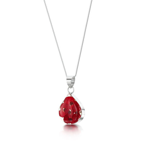 The image shows an teardrop-shaped sterling silver pendant. The pendant contains real poppy flowers in a clear resin mounted within sterling silver on an 18 inch chain.